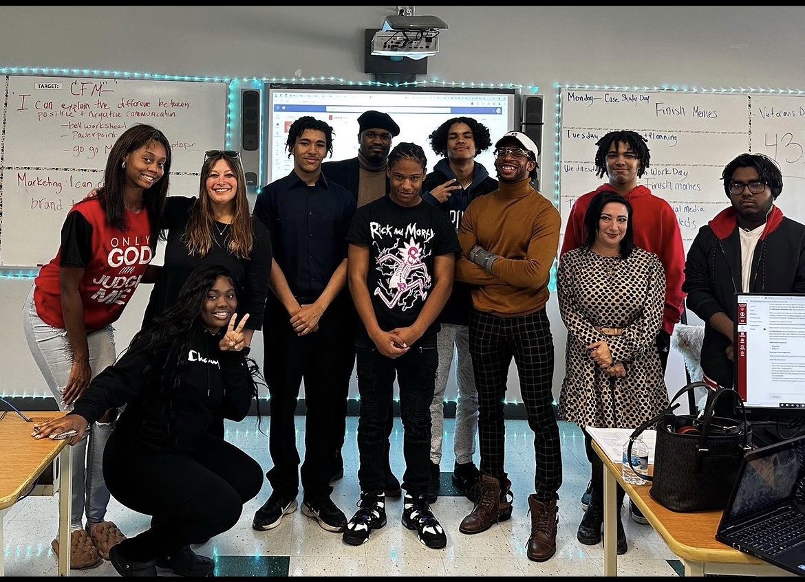 Youth program participants and facilitators gathered in a classroom